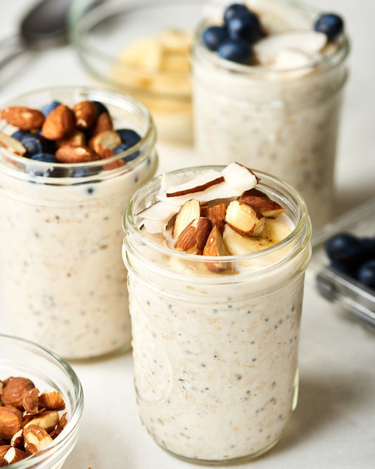 Creamy overnight oats with chia seeds and fresh strawberries in a glass jar.